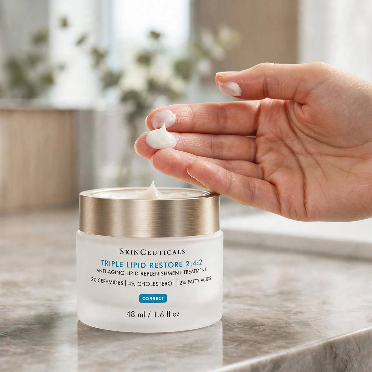 SkinCeuticals Triple Lipid Restore 2:4:2 48ml — hand applying the product