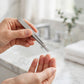 Tweezerman Classic Stainless Steel Slant Tweezer — hand applying the product