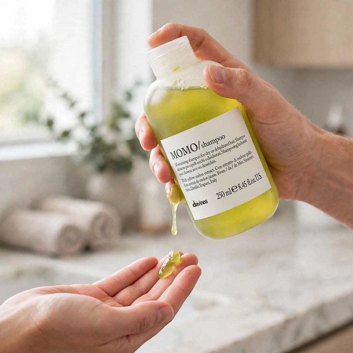 Davines MOMO Moisturizing Shampoo 250ml — hand applying the product