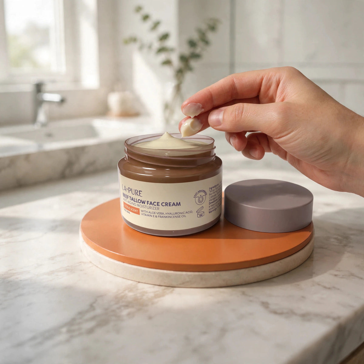 LA+ Pure Beef Tallow Face Cream 4oz — hand applying the product