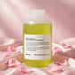 Davines MOMO Moisturizing Shampoo 250ml — product on blush-pink satin with rose petals
