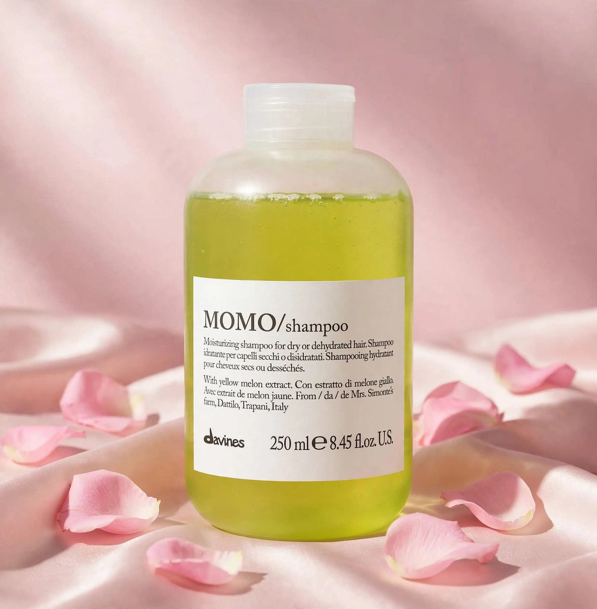 Davines MOMO Moisturizing Shampoo 250ml — product on blush-pink satin with rose petals