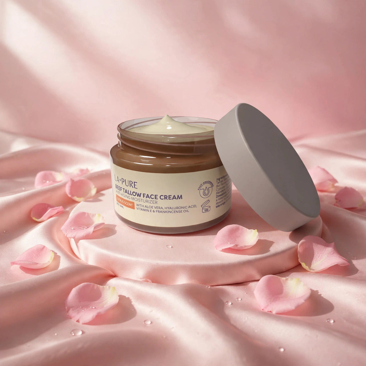 LA+ Pure Beef Tallow Face Cream 4oz — product on blush-pink satin with rose petals