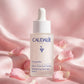 Caudalie Vinoperfect Brightening Dark Spot Serum 30ml — product on blush-pink satin with rose petals