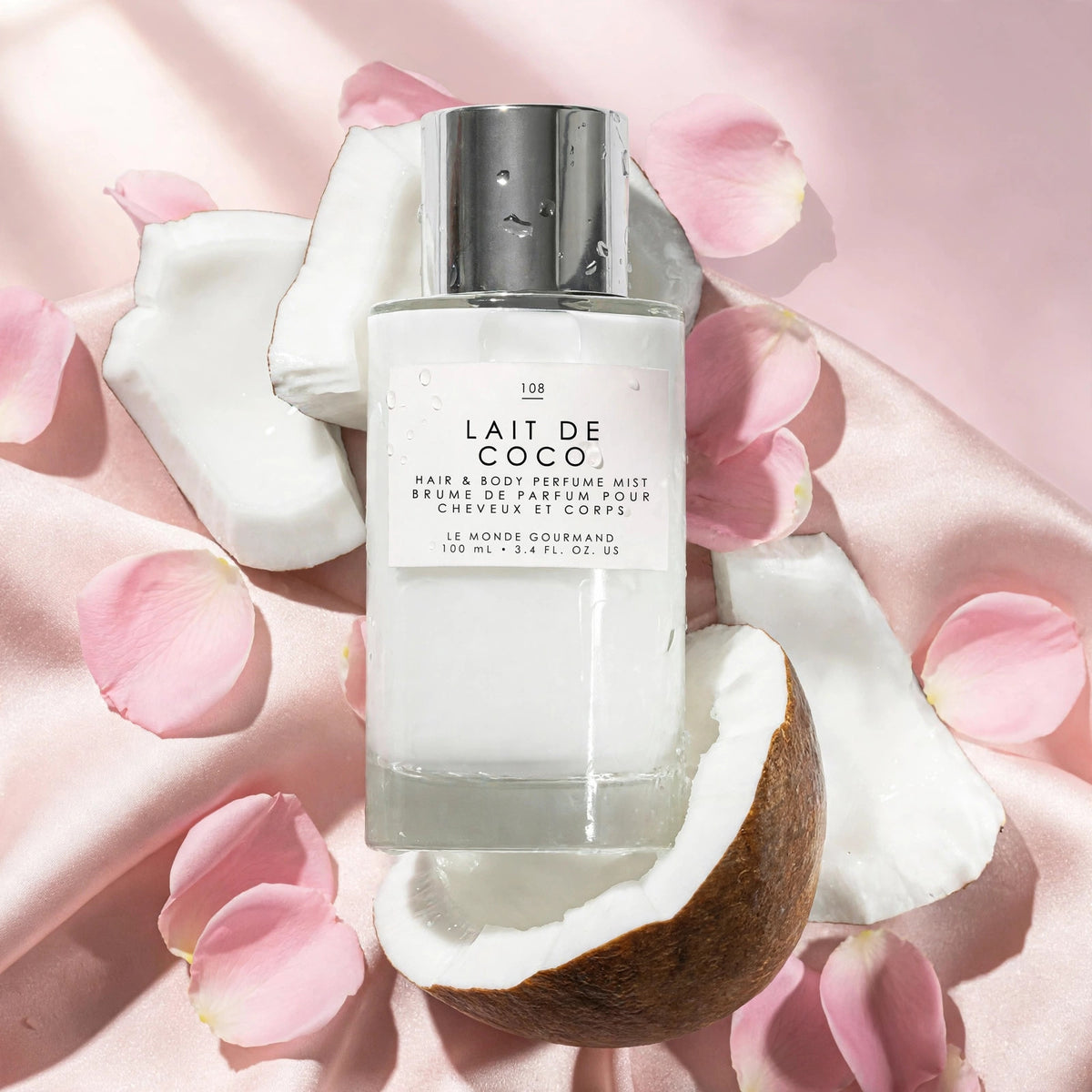 Le Monde Gourmand Lait de Coco Hair & Body Mist 100ml on blush satin with rose petals - view 4