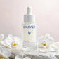 Caudalie Vinoperfect Brightening Dark Spot Serum 30ml — product with white orchids in spa setting