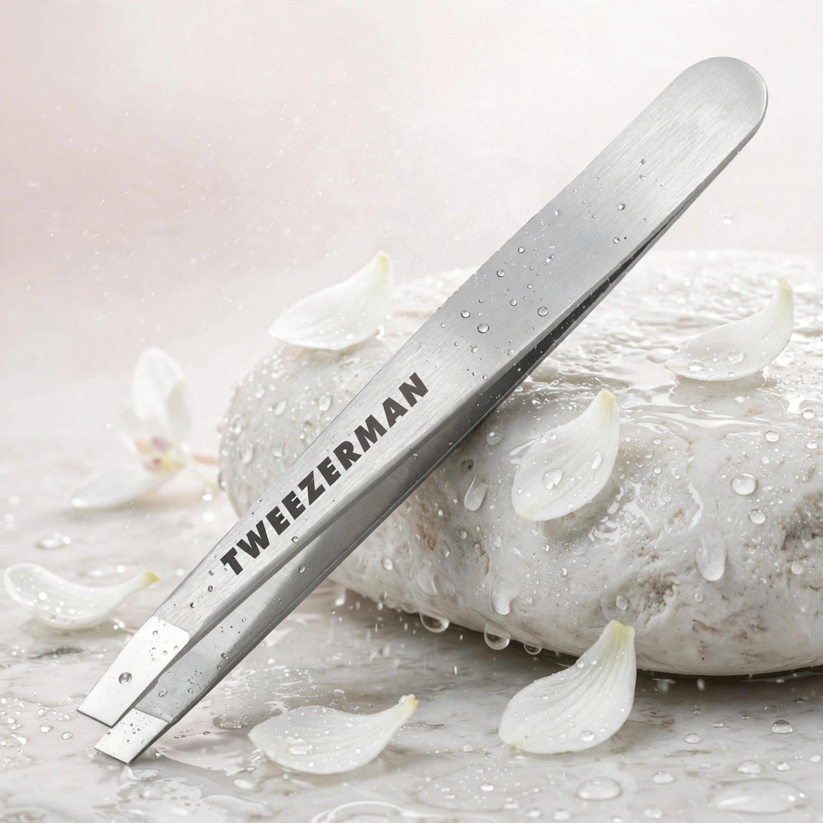 Tweezerman Classic Stainless Steel Slant Tweezer — product with white orchids in spa setting