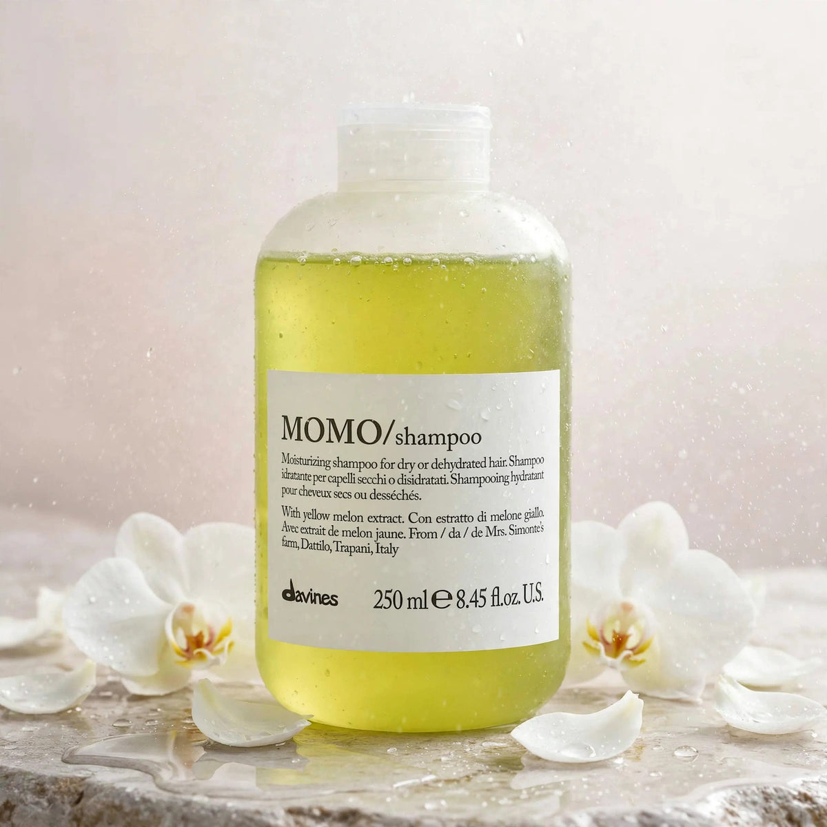 Davines MOMO Moisturizing Shampoo 250ml — product with white orchids in spa setting