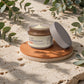 LA+ Pure Beef Tallow Face Cream 4oz — product on travertine stone with eucalyptus