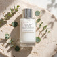 Le Monde Gourmand Lait de Coco Hair & Body Mist 100ml on travertine stone with eucalyptus - view 1