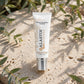 Alastin HydraTint Pro Mineral Sunscreen SPF 36 on sunlit travertine stone with eucalyptus leaves